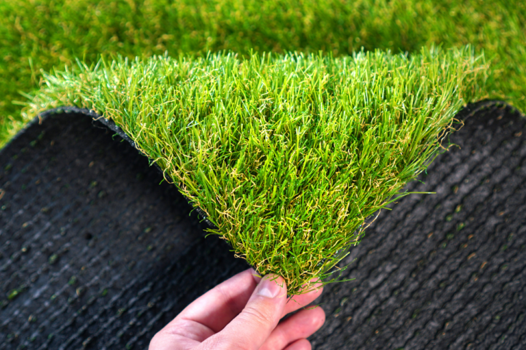 Spot-cleaning a stain on artificial turf with a turf-safe cleaner