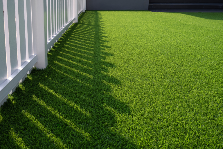 Well-designed backyard dog run with artificial turf, shade, and pavers in Arizona