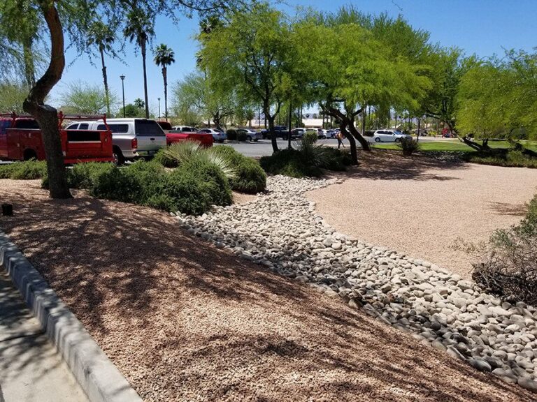 Dry creek bed and rock controlling erosion in an Arizona yard