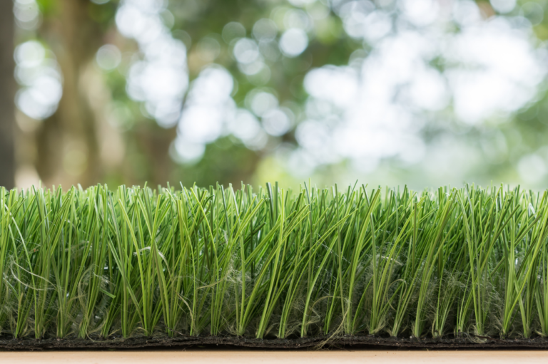 Rinsing and deep cleaning artificial turf with a garden hose in Arizona