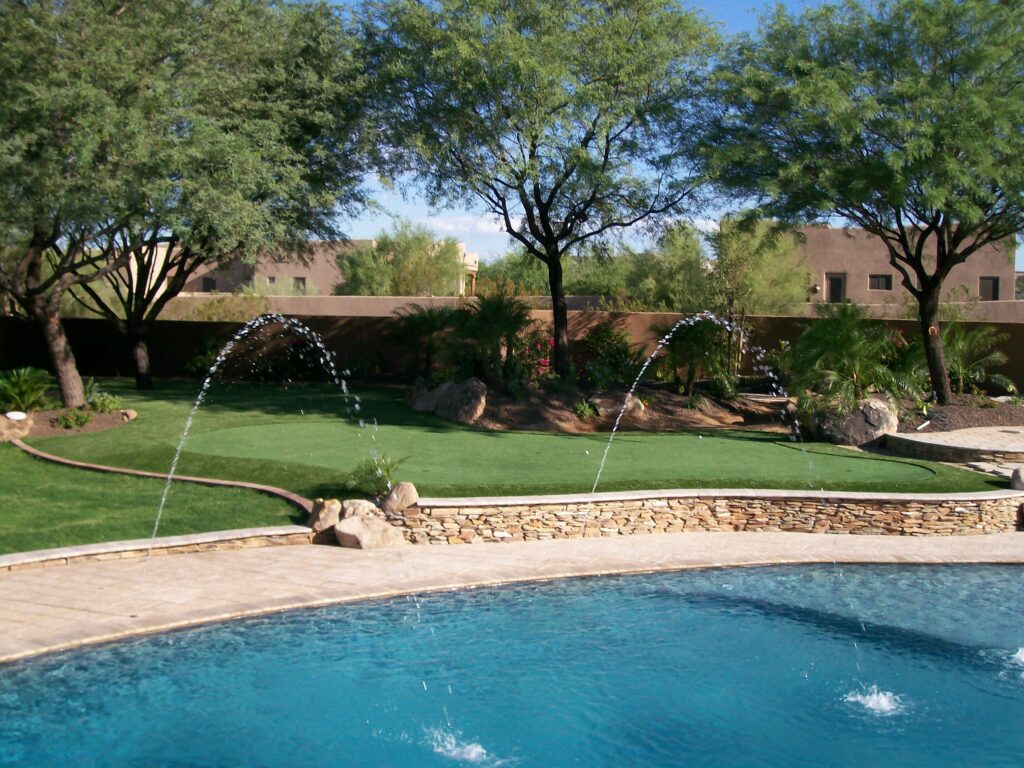 Freshly rinsed artificial turf lawn in a Phoenix backyard after monsoon season