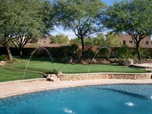 Freshly rinsed artificial turf lawn in a Phoenix backyard after monsoon season