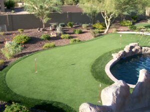 Arizona yard combining an artificial turf lawn with desert rock landscaping