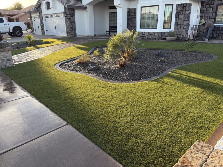 Artificial turf installed in front yard of Peoria, AZ home with free form island in the center.