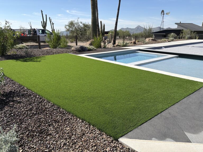 Artificial turf installed around modern pool in Scottsdale, AZ by Turfscapes of Arizona.
